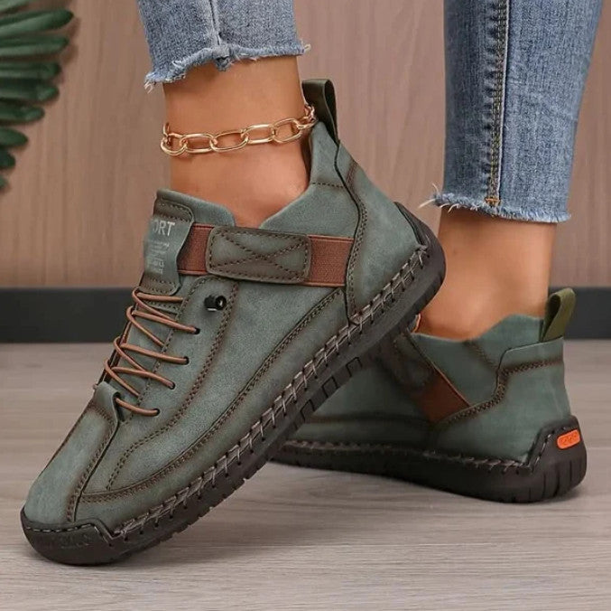 Mia Sneakers in green, worn with frayed jeans