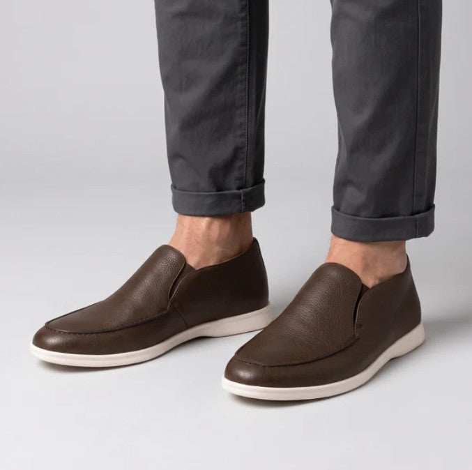 Brown Aurex loafers worn with cuffed grey trousers